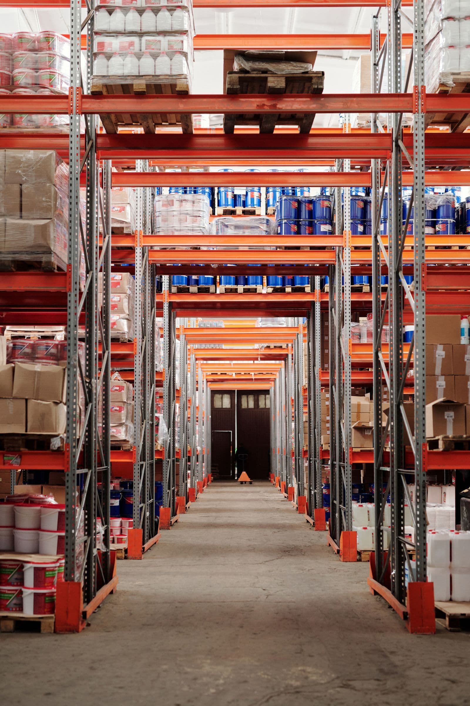 Organised warehouse racking in a bright industrial storage environment.